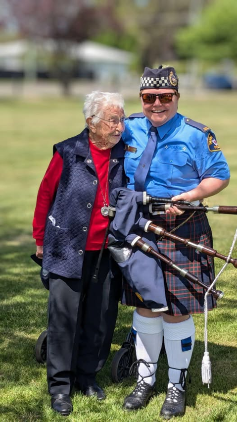 Pipe member holding bag pipes with another person